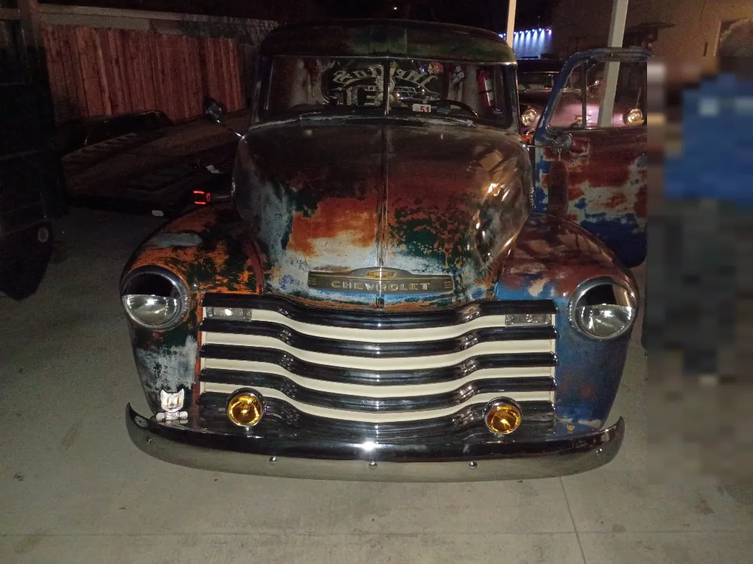 Vintage Chevrolet pickup with a chrome grille and patina paintwork parked indoors during a no-start diagnosis